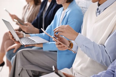 Group of people using different gadgets indoors, closeup. Modern technology