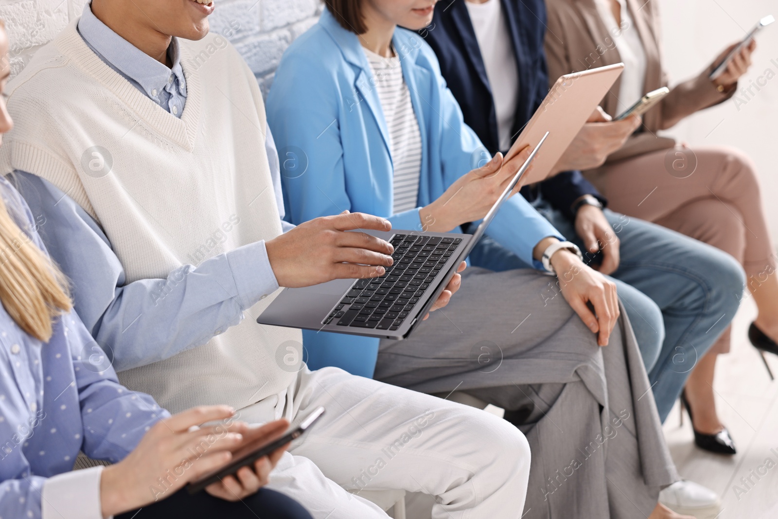 Photo of Group of people using different gadgets indoors, closeup. Modern technology