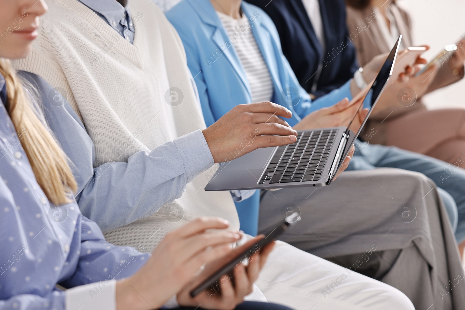 Photo of Group of people using different gadgets indoors, closeup. Modern technology