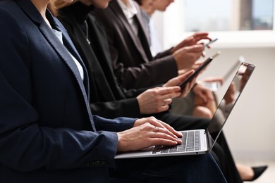 Photo of Group of people using different gadgets indoors, closeup. Modern technology