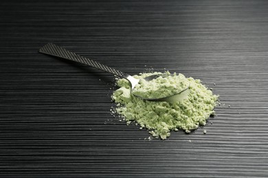 Photo of Pile of wasabi powder and spoon on black textured table