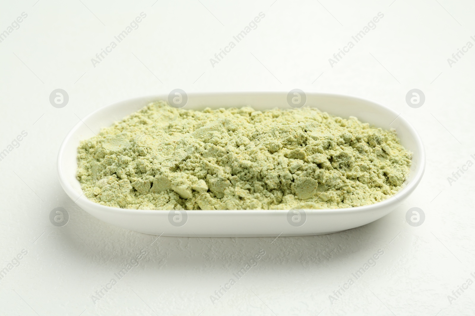 Photo of Dry wasabi powder on white textured table, closeup