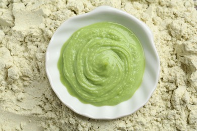 Photo of Bowl with wasabi paste on dry powder, top view