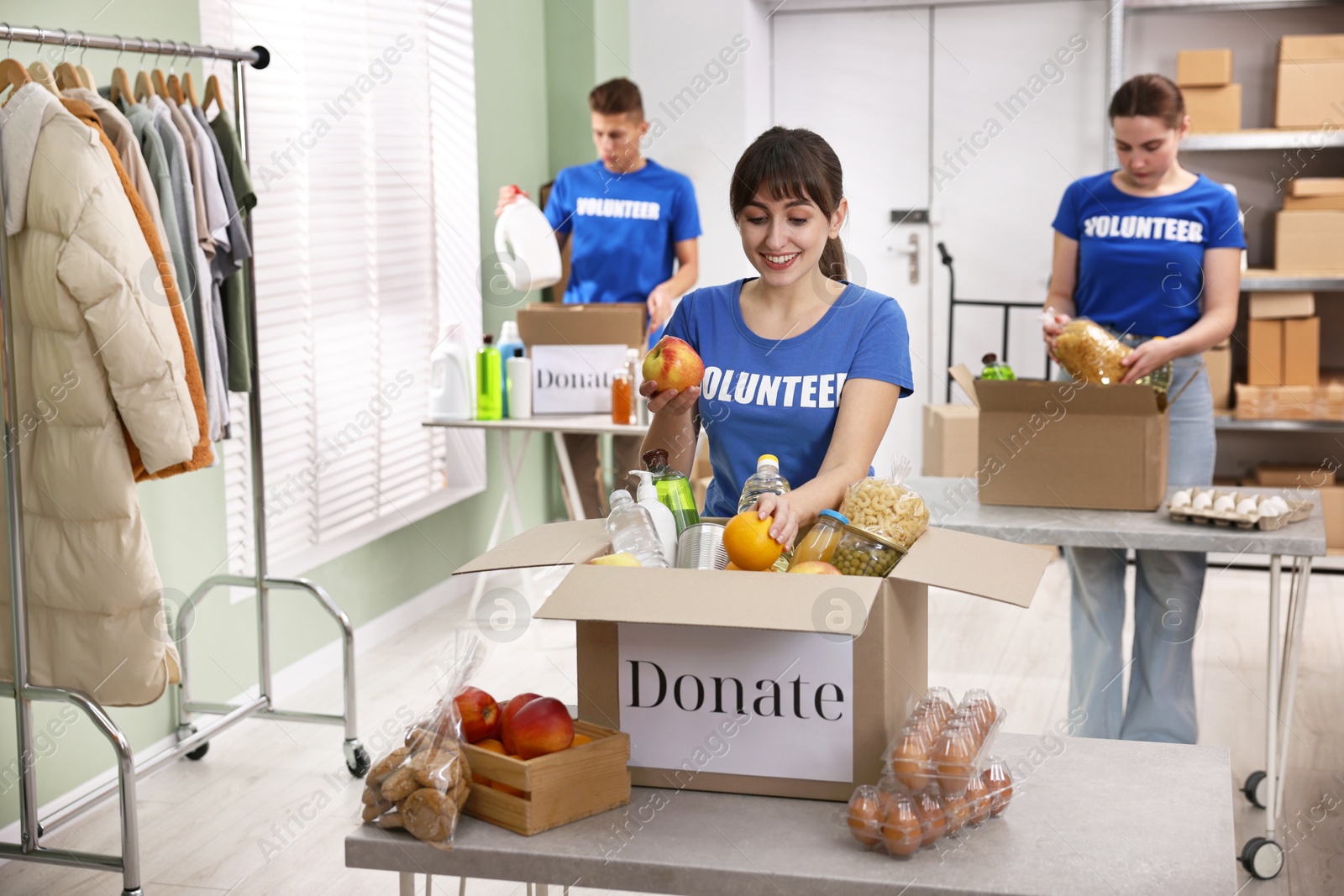 Photo of Volunteers packing food donations at tables indoors