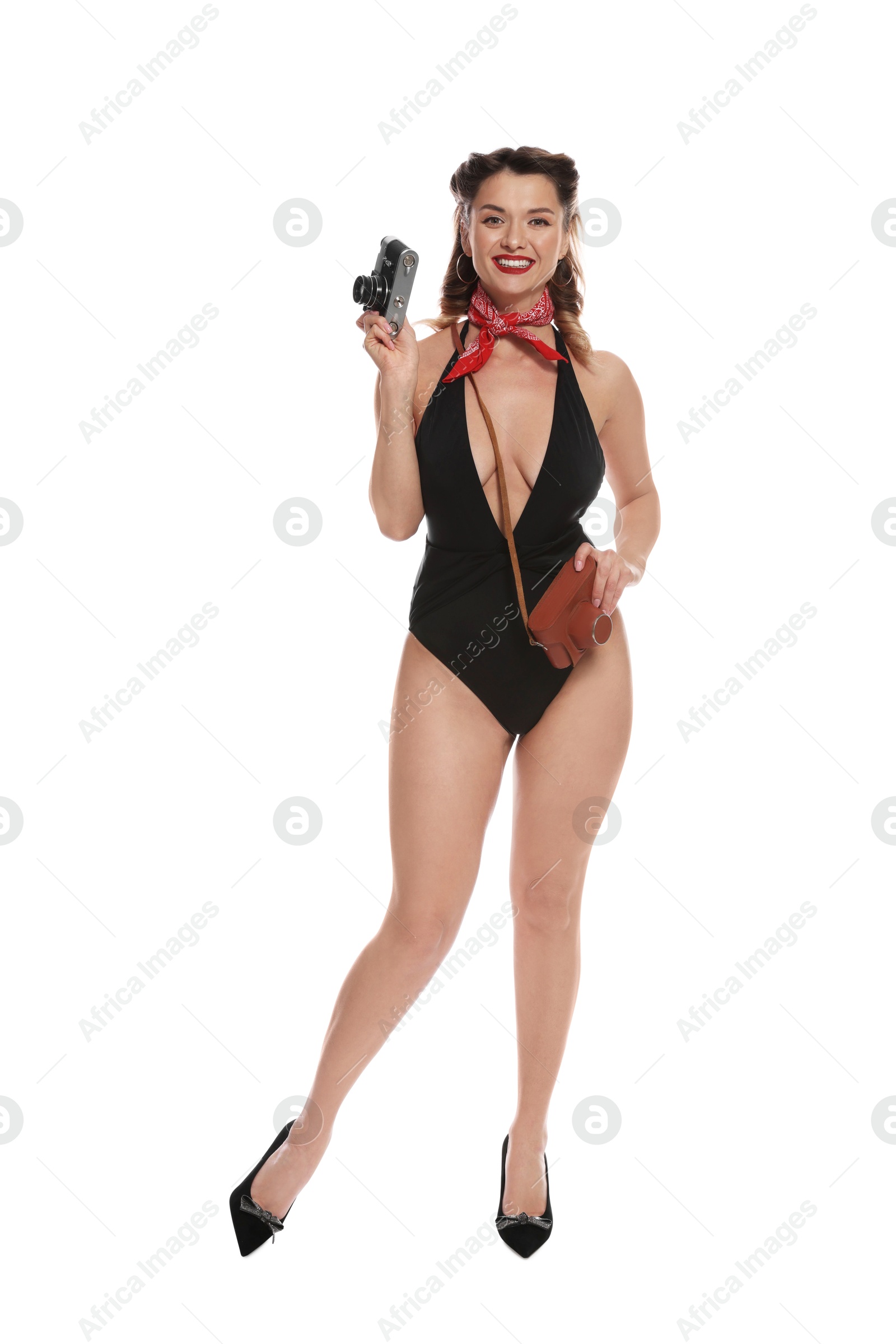 Photo of Happy pin-up woman in swimsuit with vintage camera on white background