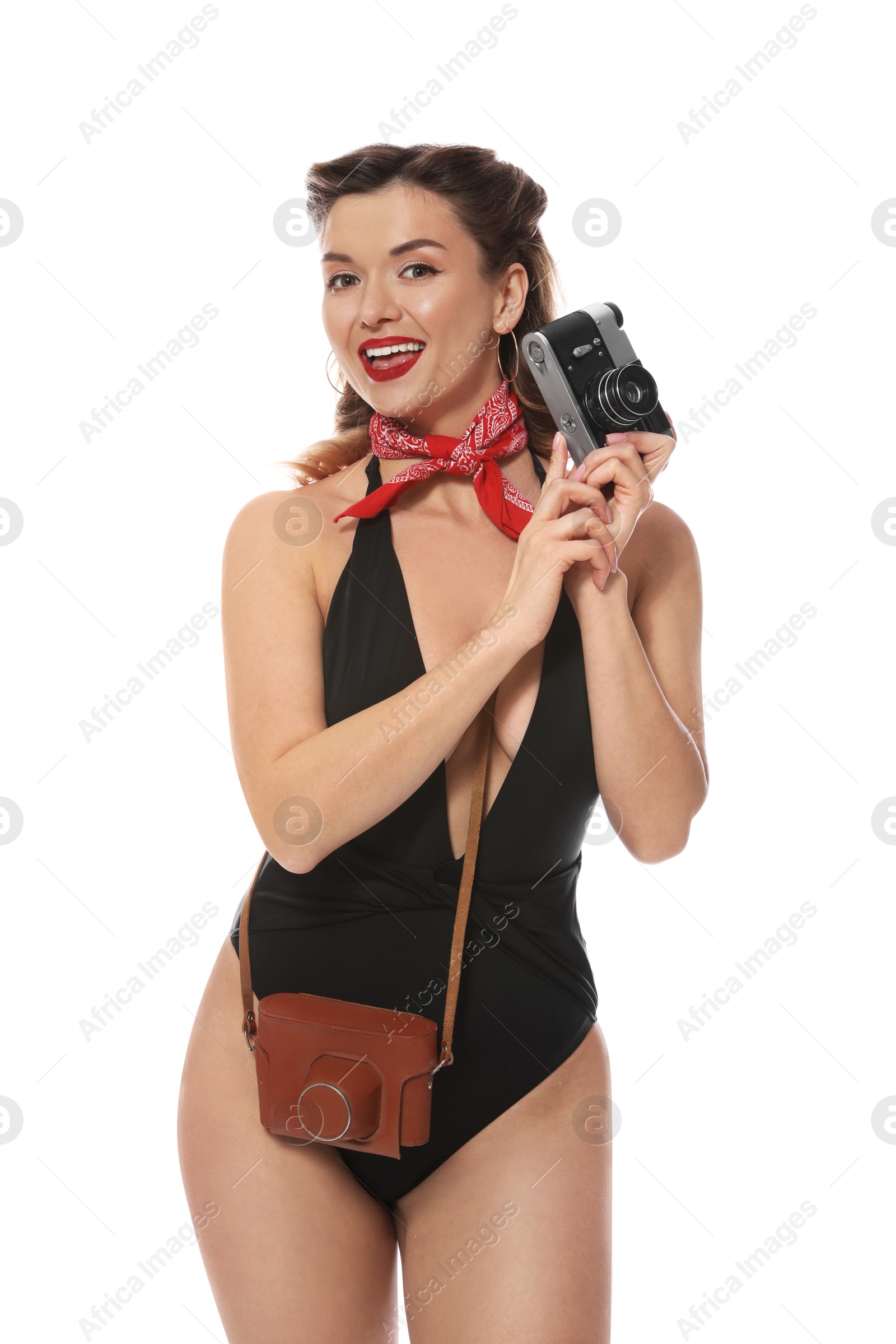 Photo of Happy pin-up woman in swimsuit with vintage camera on white background