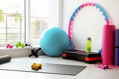 Many different fitness equipment and accessories indoors