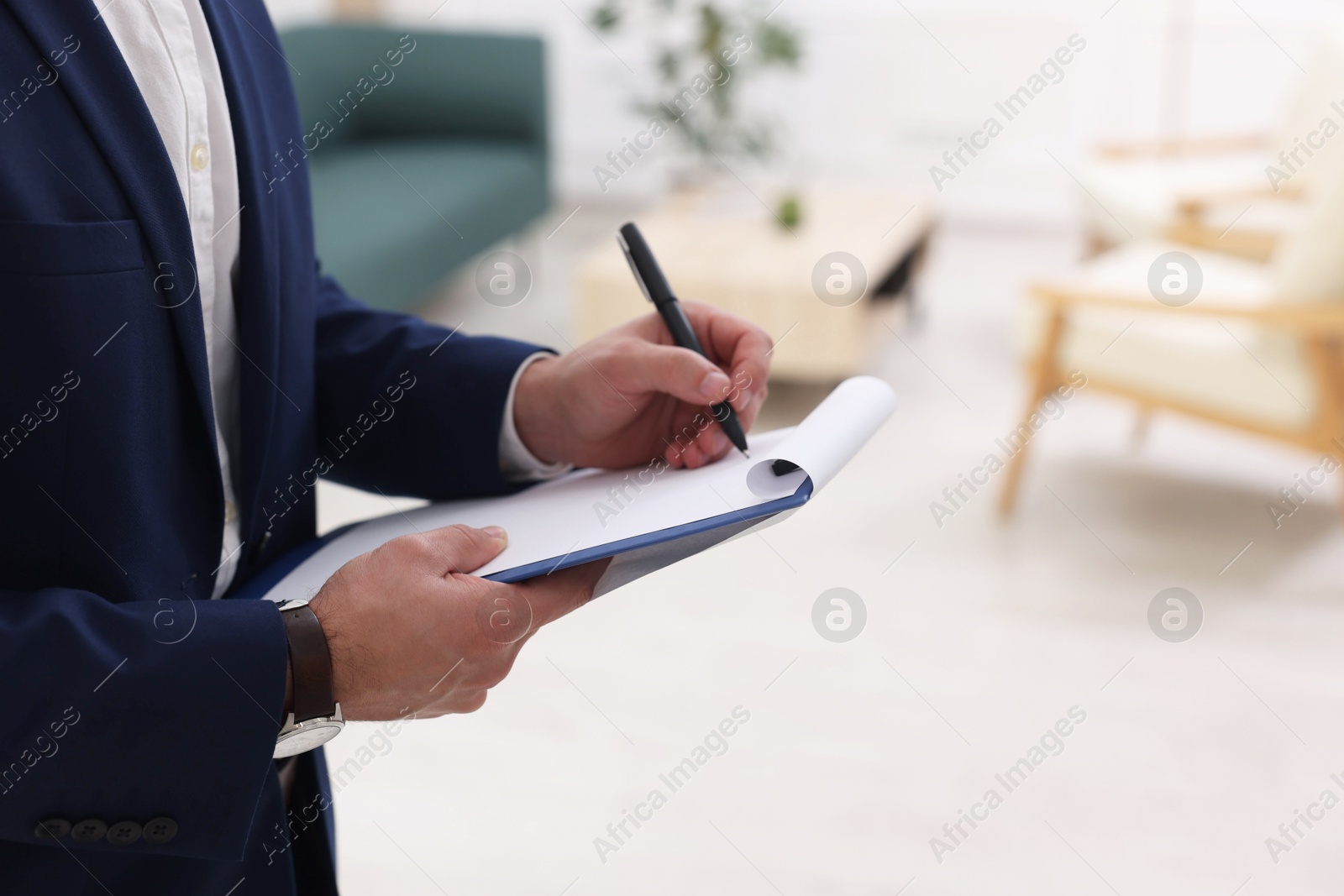 Photo of Real estate appraisal. Inspector with clipboard conducting property valuation at home, closeup. Space for text