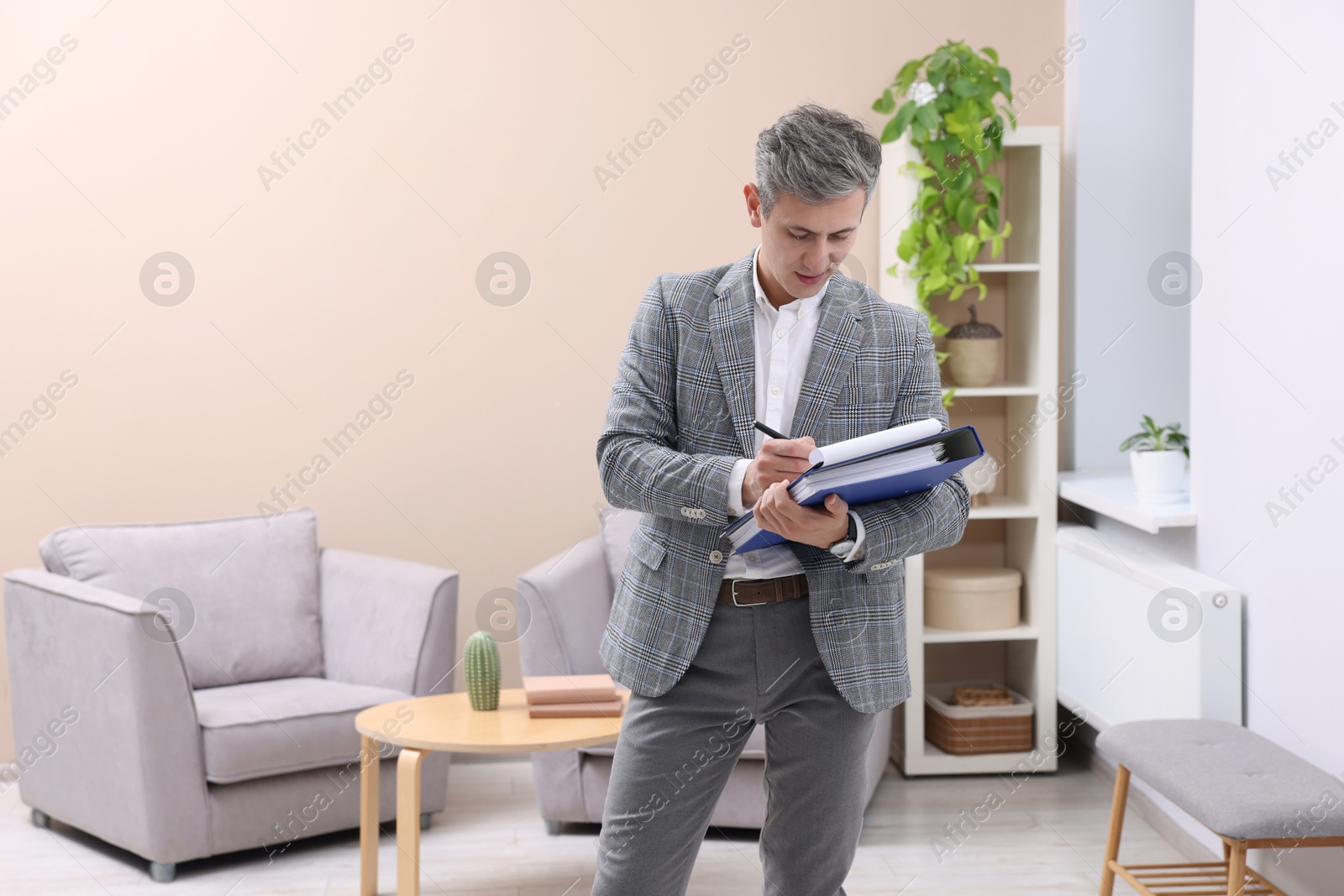 Photo of Real estate appraisal. Inspector with clipboard conducting property valuation at home. Space for text