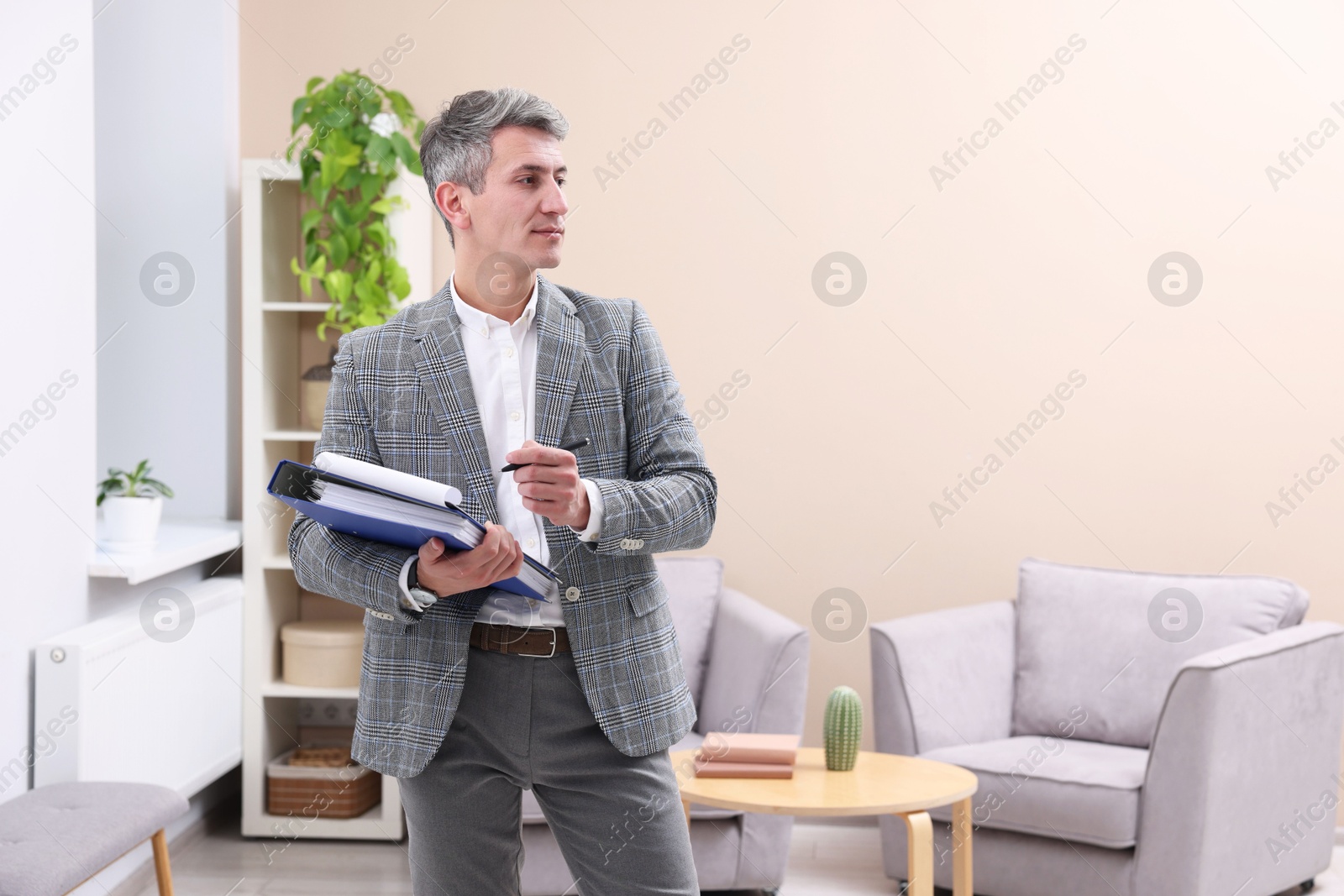 Photo of Real estate appraisal. Inspector with clipboard conducting property valuation at home. Space for text