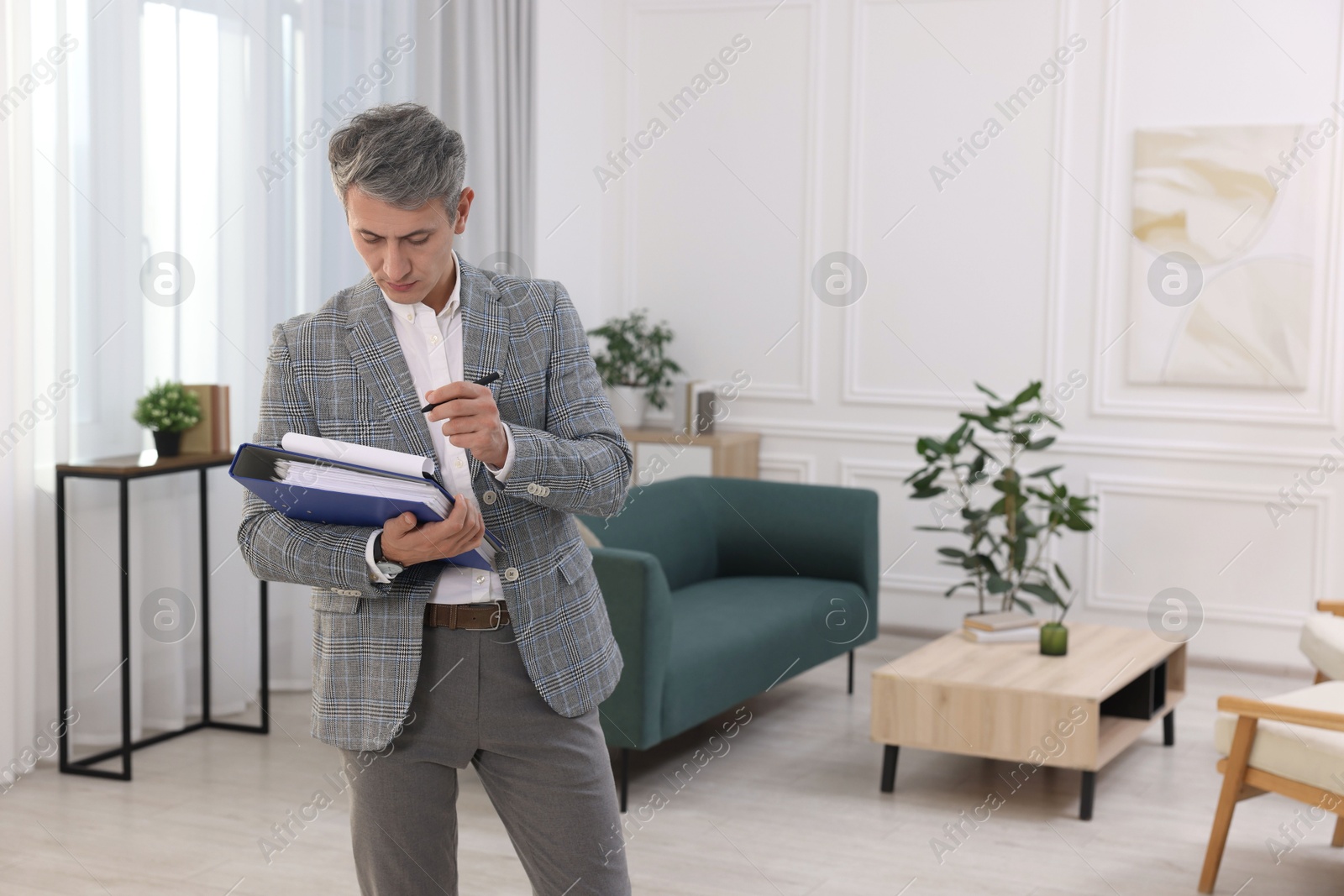 Photo of Real estate appraisal. Inspector with clipboard conducting property valuation at home. Space for text