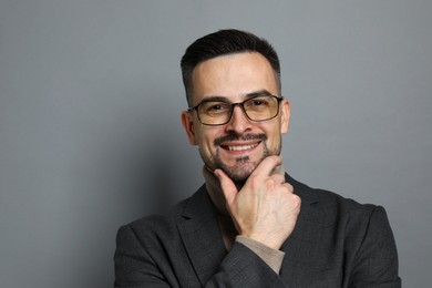 Photo of Portrait of handsome middle aged man on grey background