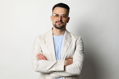 Photo of Portrait of handsome middle aged man on light background