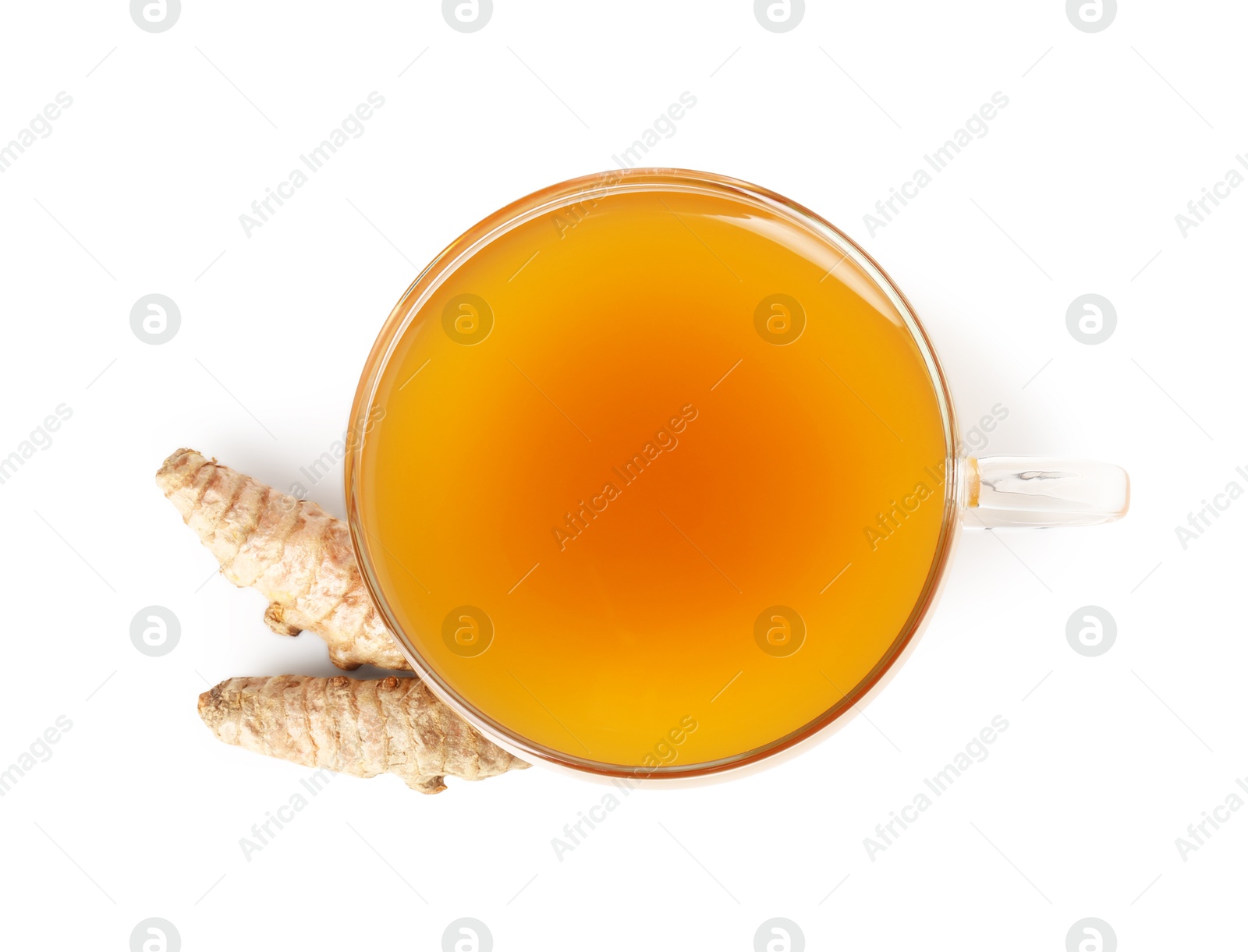 Photo of Aromatic turmeric tea in glass cup and roots isolated on white, top view