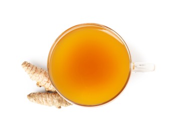 Photo of Aromatic turmeric tea in glass cup and roots isolated on white, top view