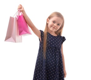 Little girl with shopping bags on white background