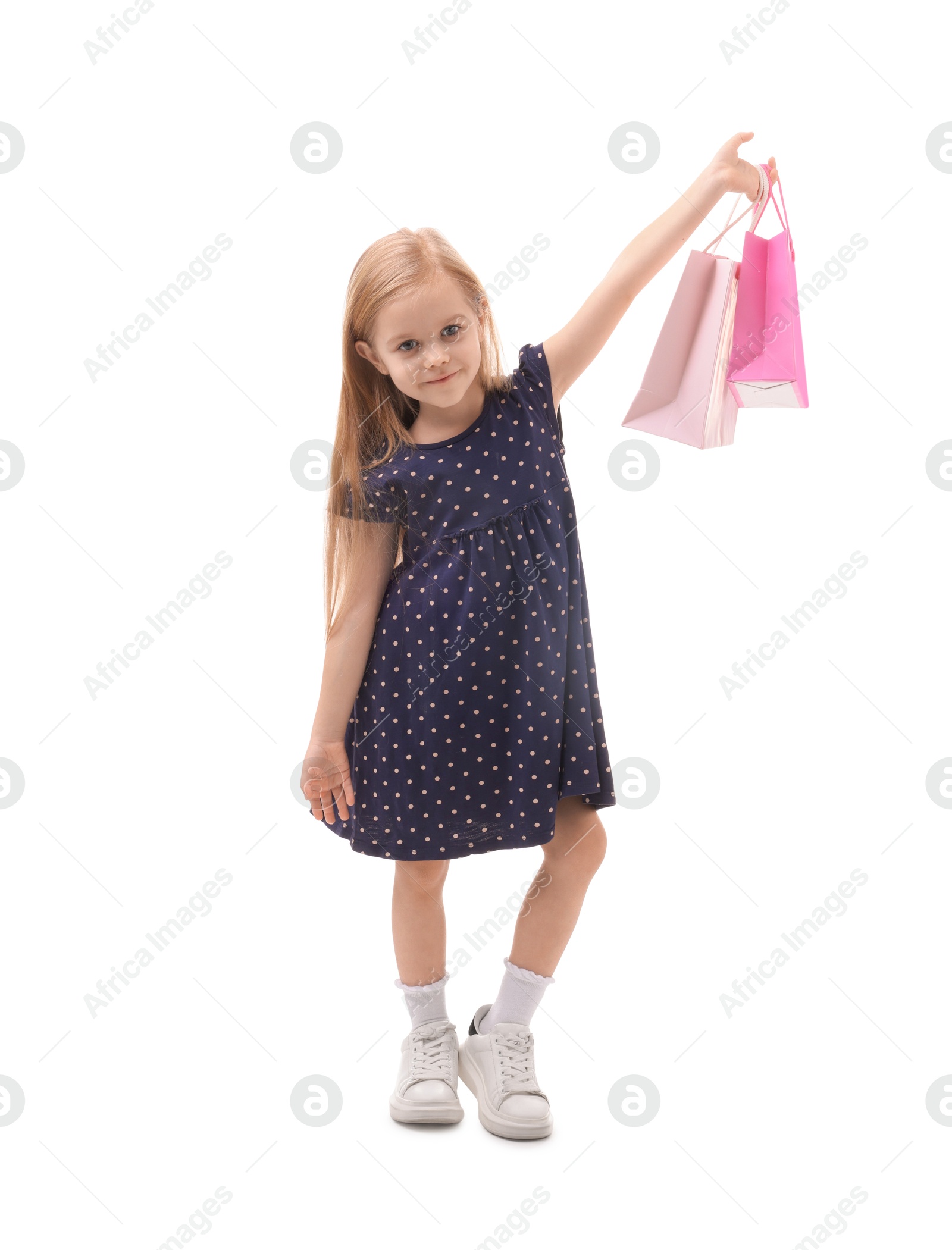 Photo of Little girl with shopping bags on white background