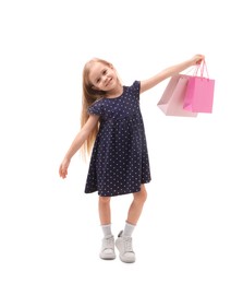 Little girl with shopping bags on white background