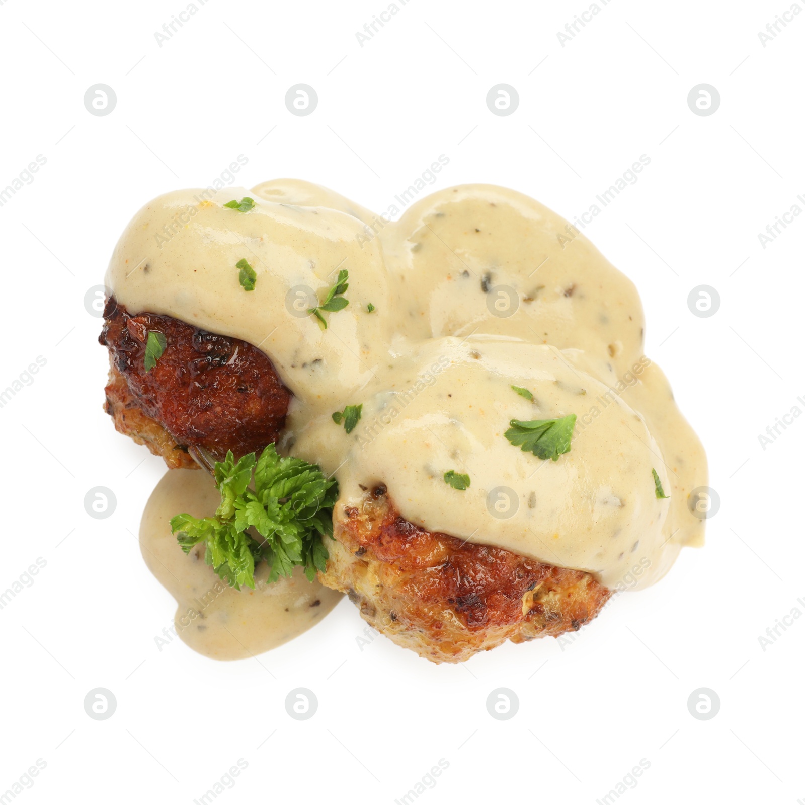 Photo of Delicious meatballs with creamy sauce isolated on white, above view