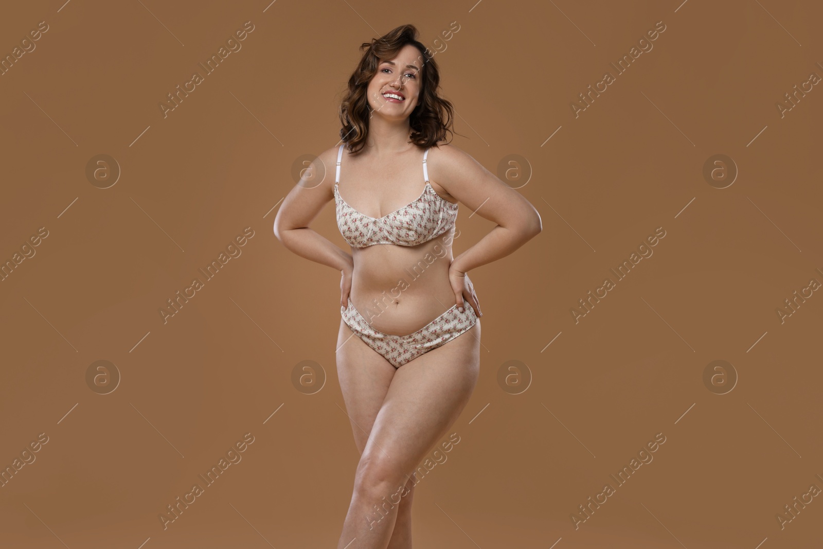 Photo of Beautiful woman in underwear on dark beige background. Cellulite problem