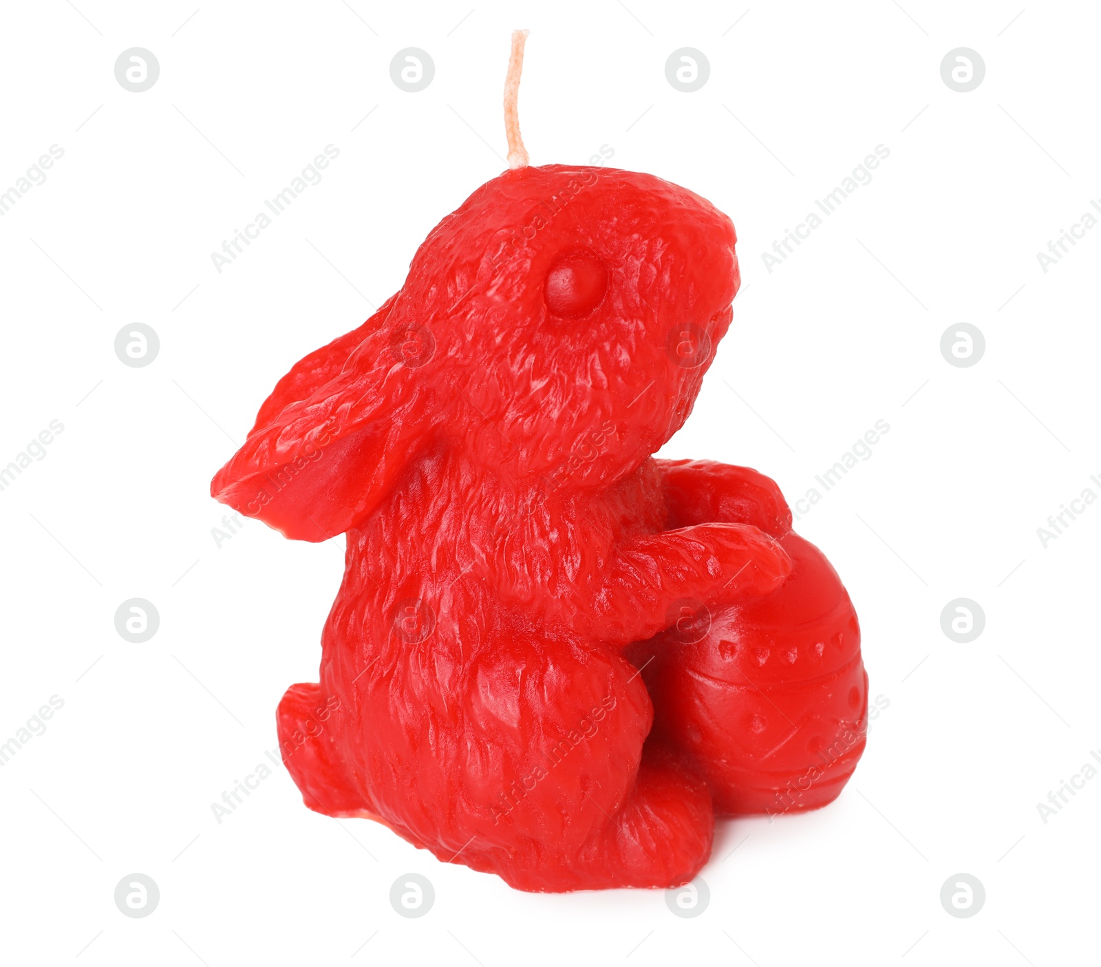 Photo of Red bunny-shaped candle isolated on white. Easter decor