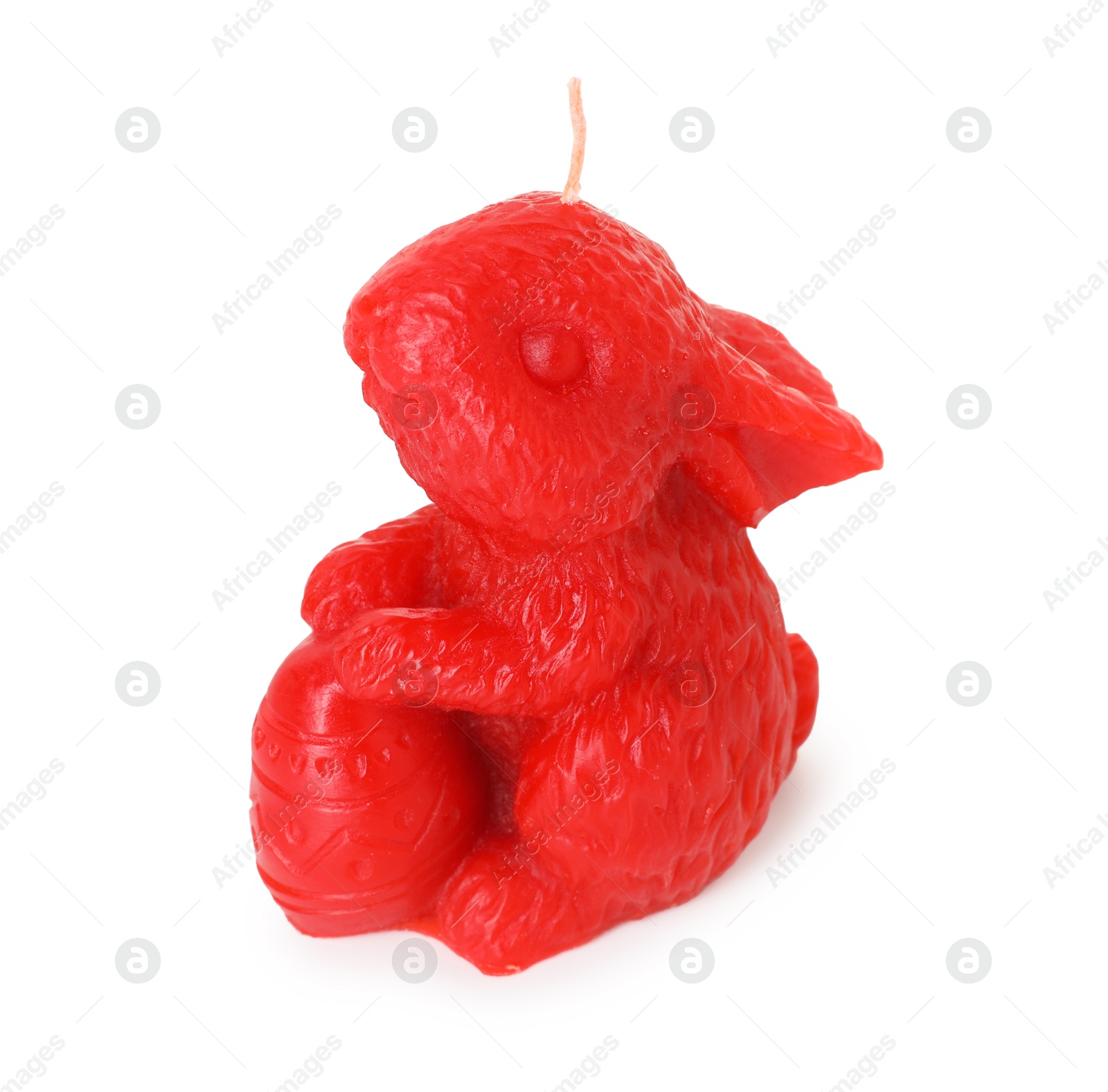 Photo of Red bunny-shaped candle isolated on white. Easter decor