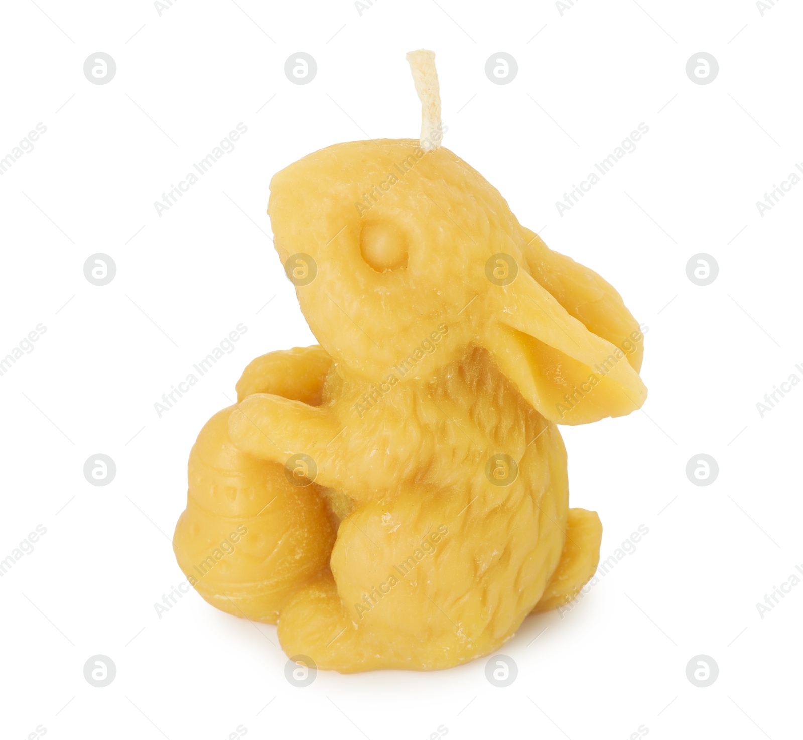 Photo of Yellow bunny-shaped candle isolated on white. Easter decor