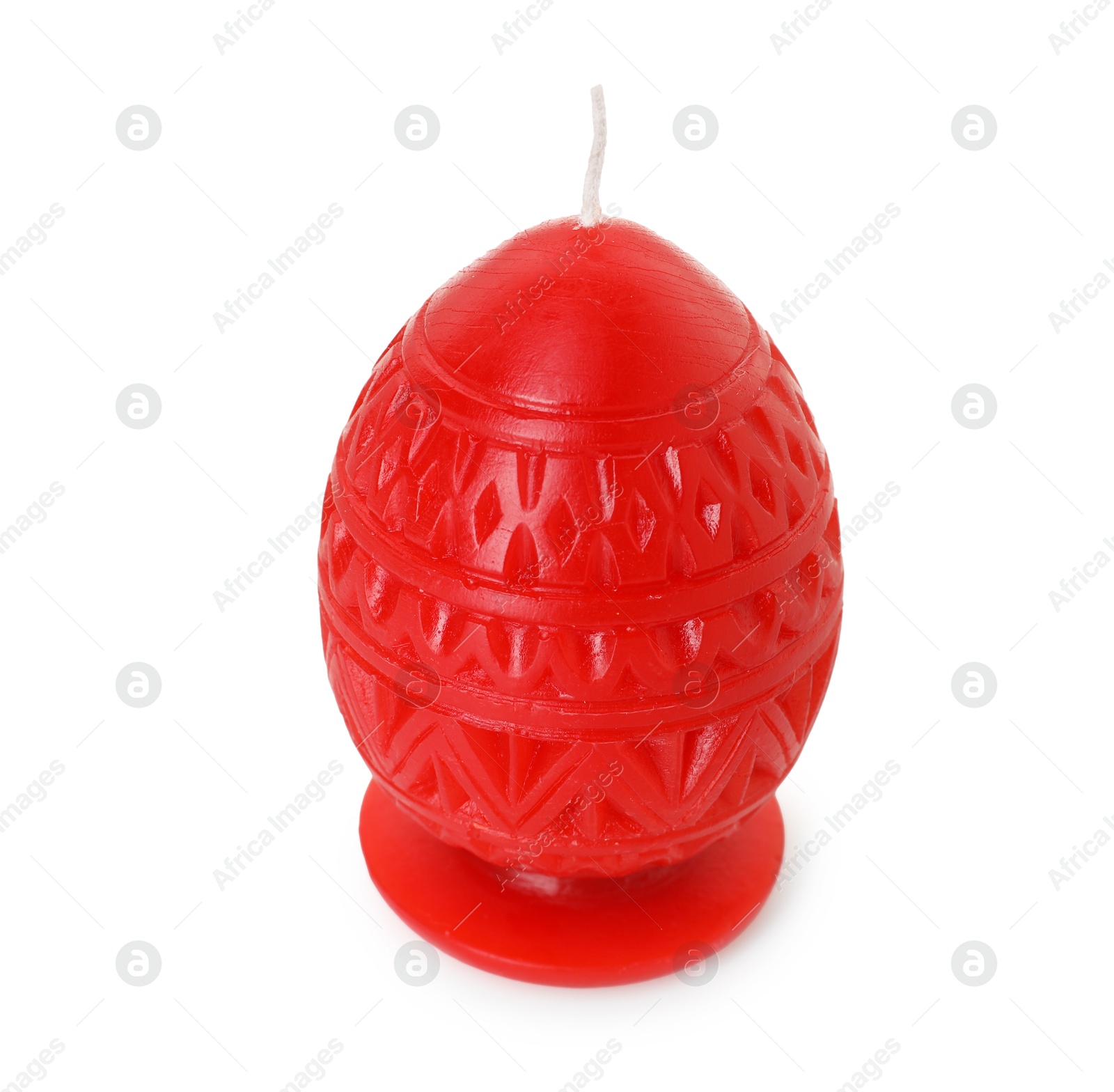 Photo of Red egg-shaped candle isolated on white. Easter decor