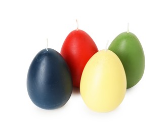 Photo of Colorful egg-shaped candles isolated on white. Easter decor