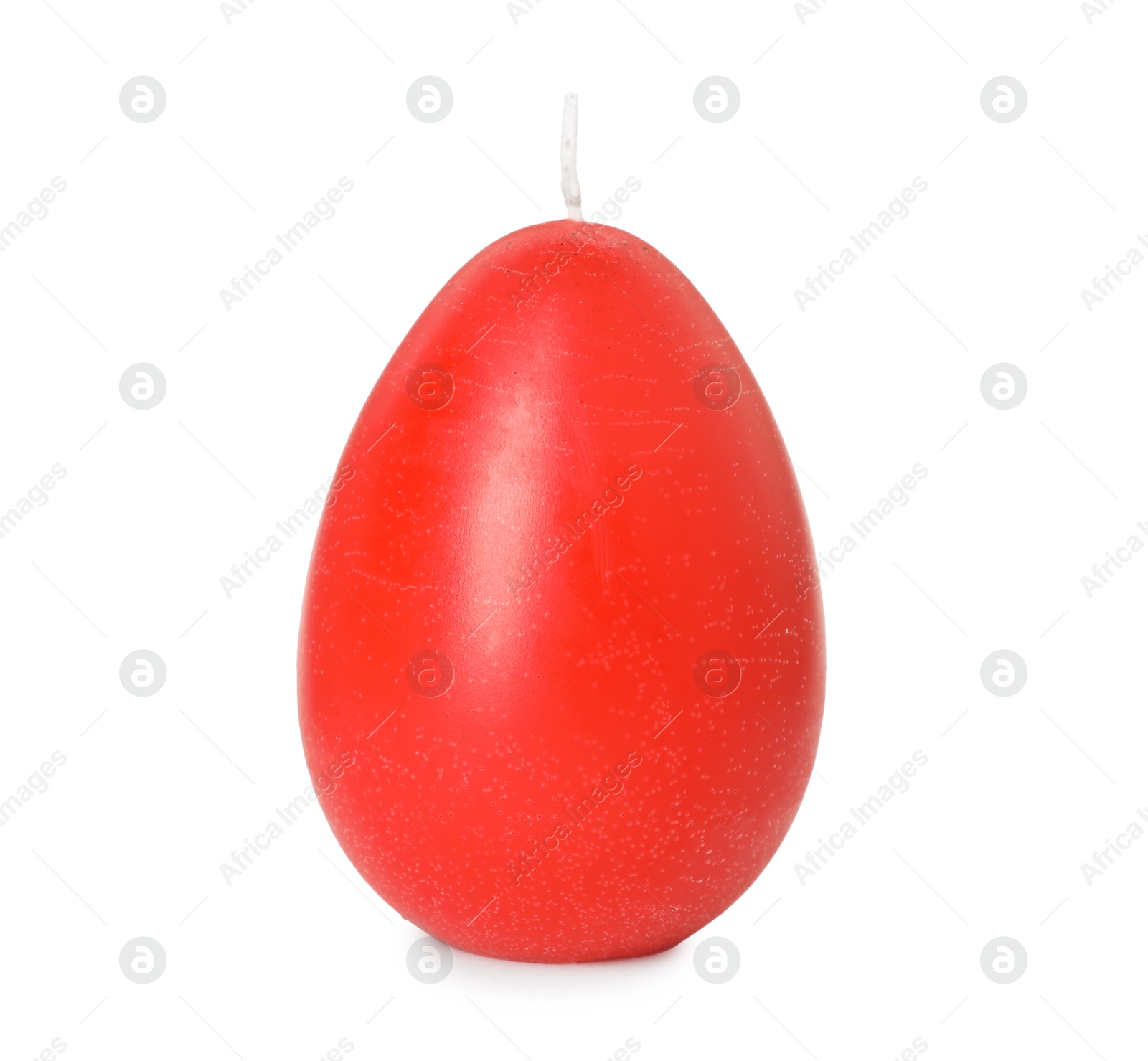 Photo of Red egg-shaped candle isolated on white. Easter decor