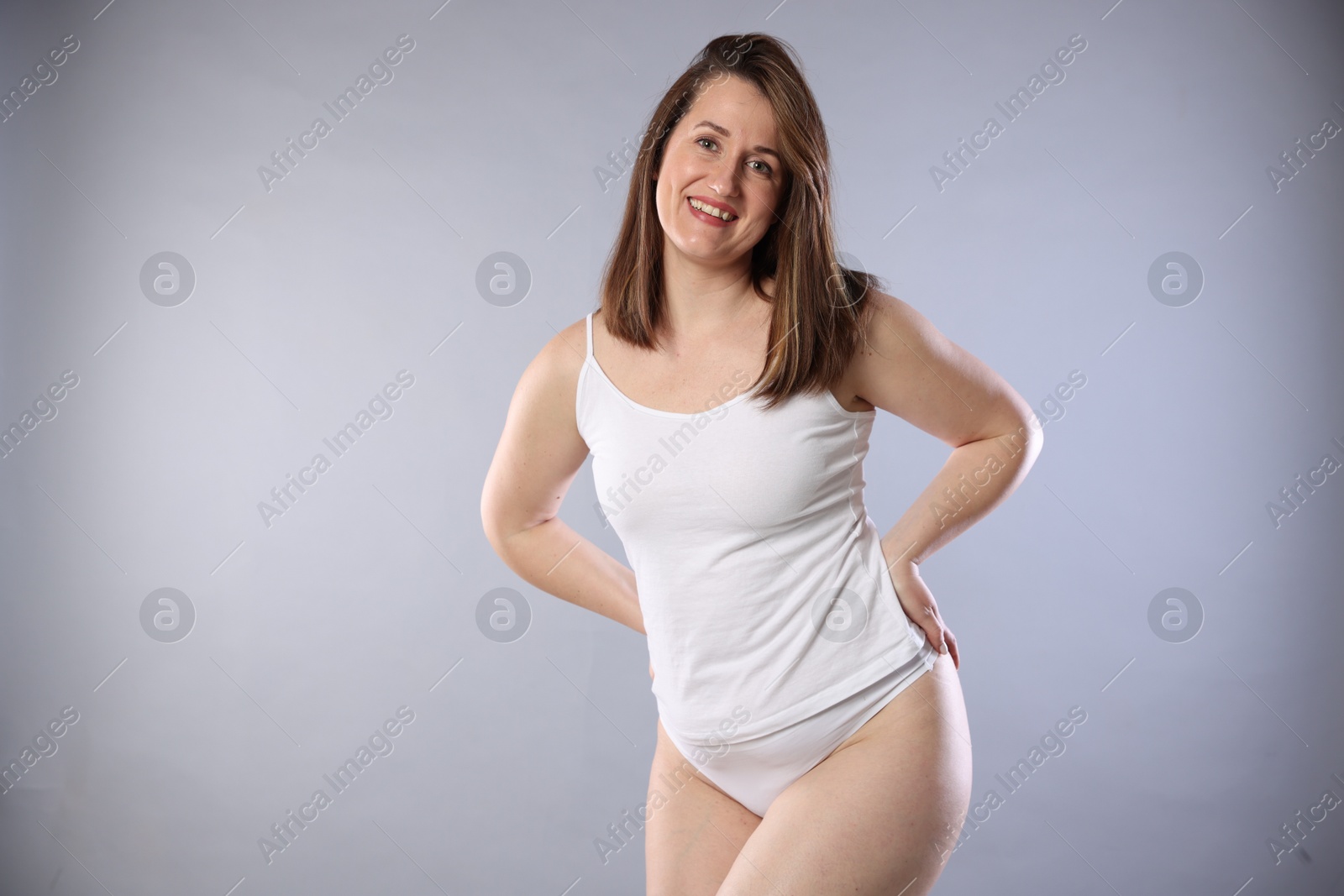 Photo of Woman in underwear on light grey background. Cellulite problem