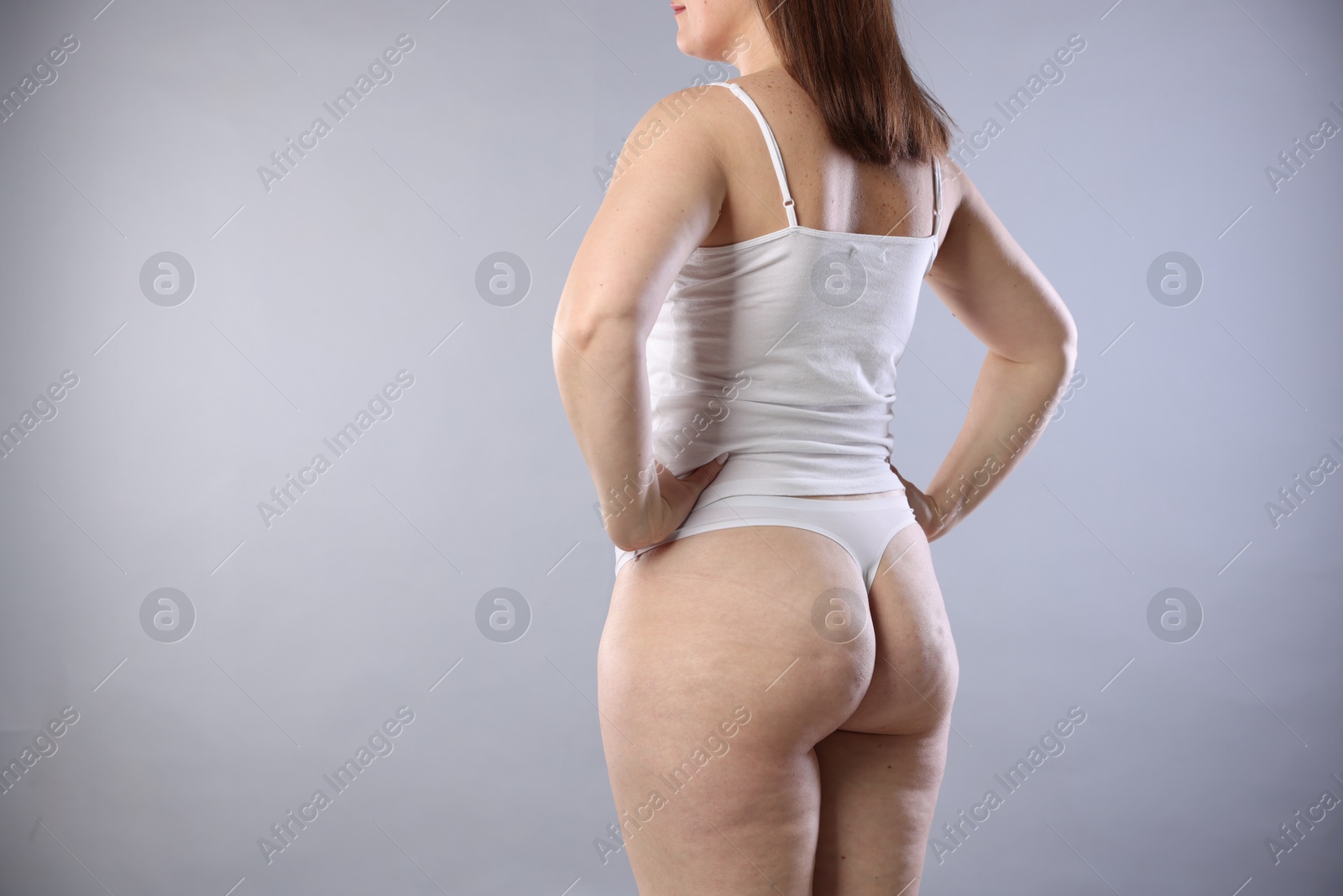 Photo of Cellulite problem. Woman in underwear on light grey background, closeup. Space for text