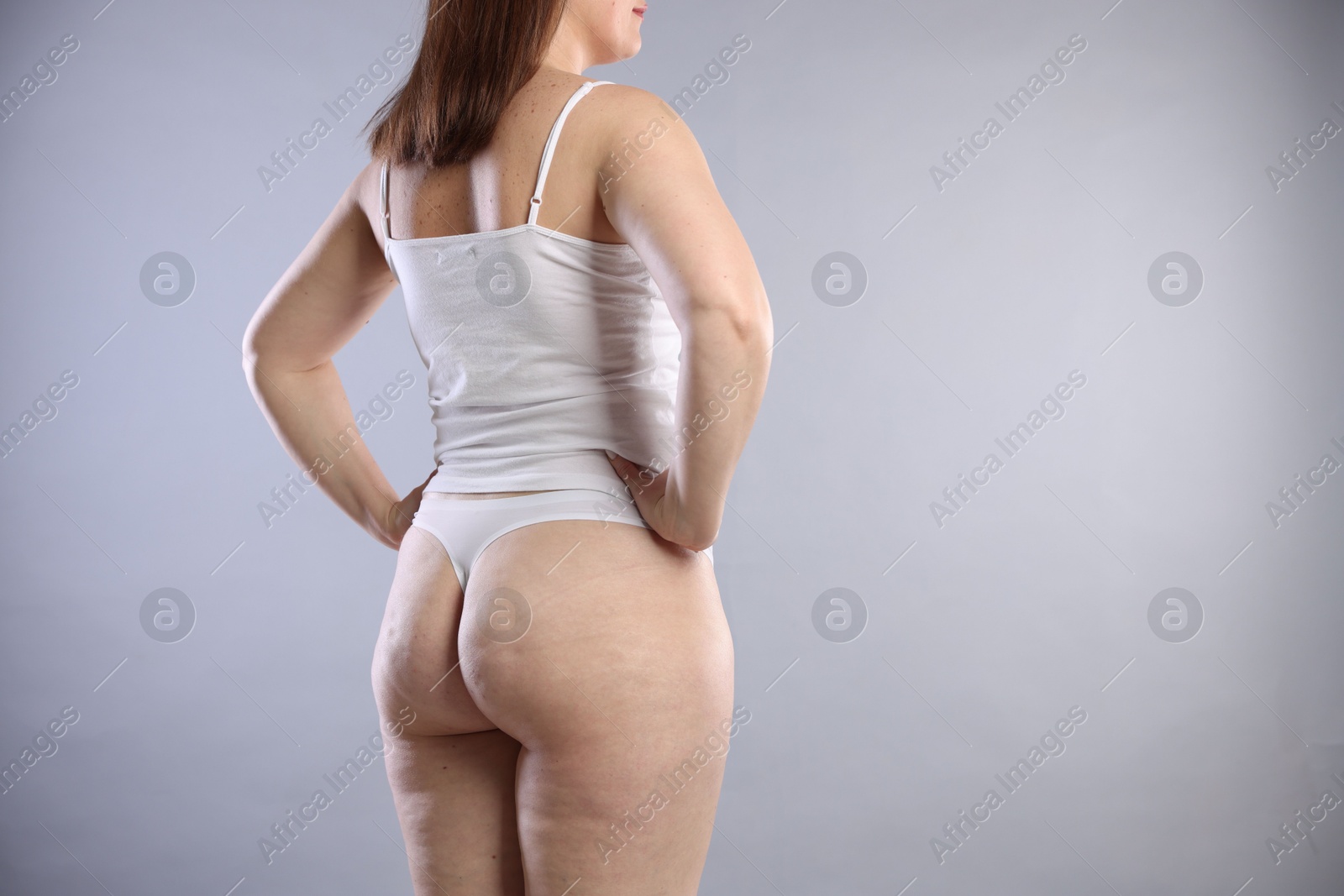 Photo of Cellulite problem. Woman in underwear on light grey background, closeup. Space for text