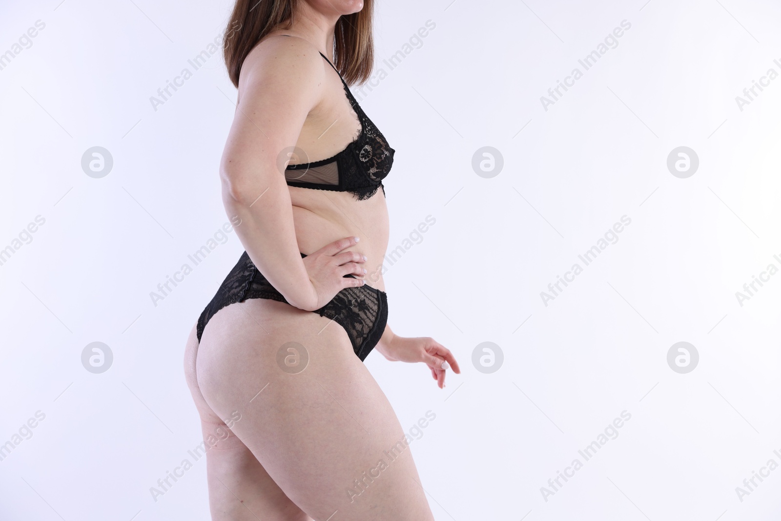 Photo of Woman in underwear on white background, closeup. Cellulite problem