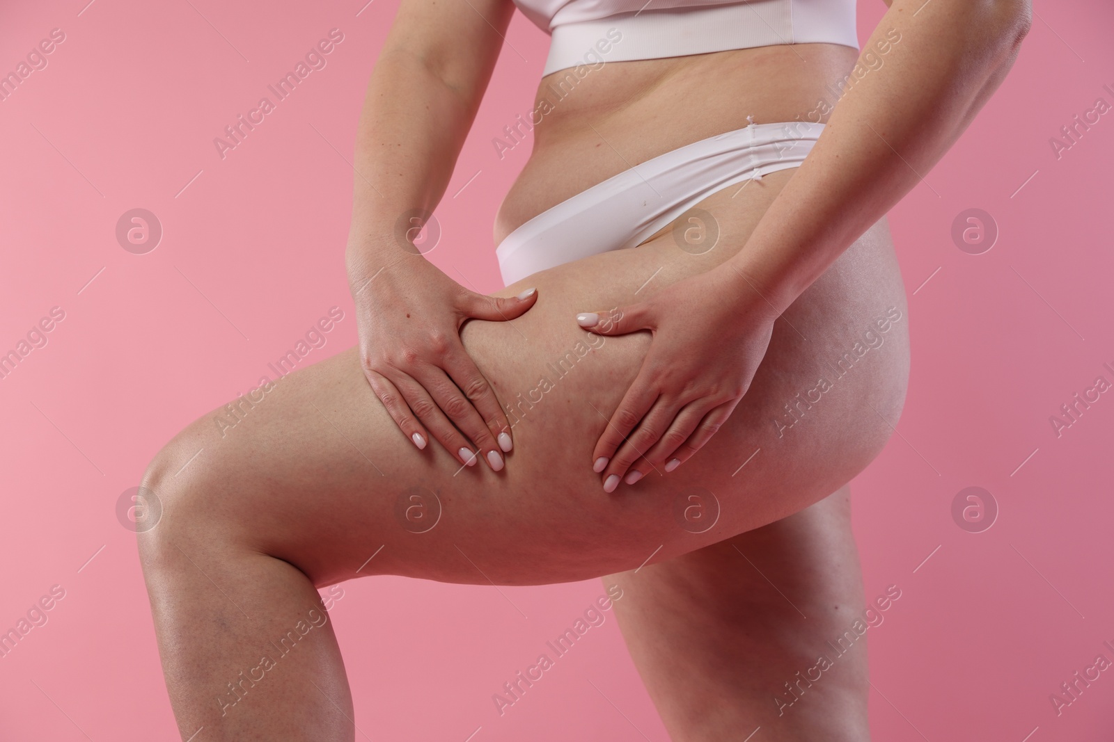 Photo of Woman with cellulite on pink background, closeup