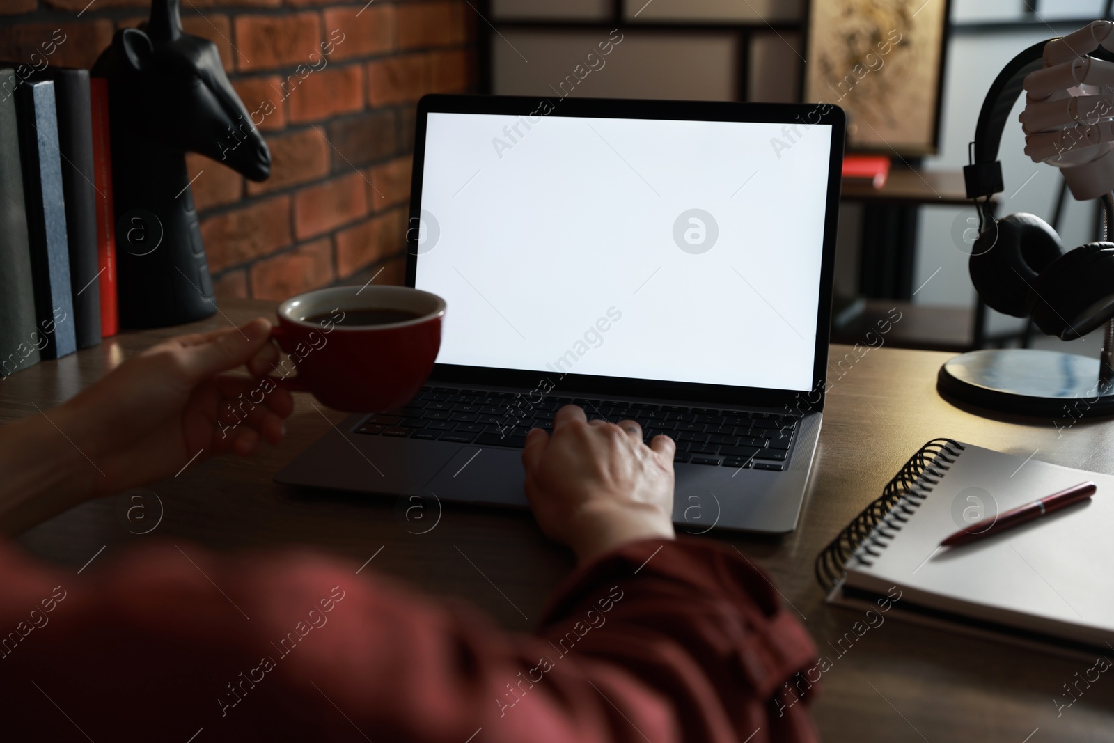 Photo of Woman working with laptop at table in office, closeup