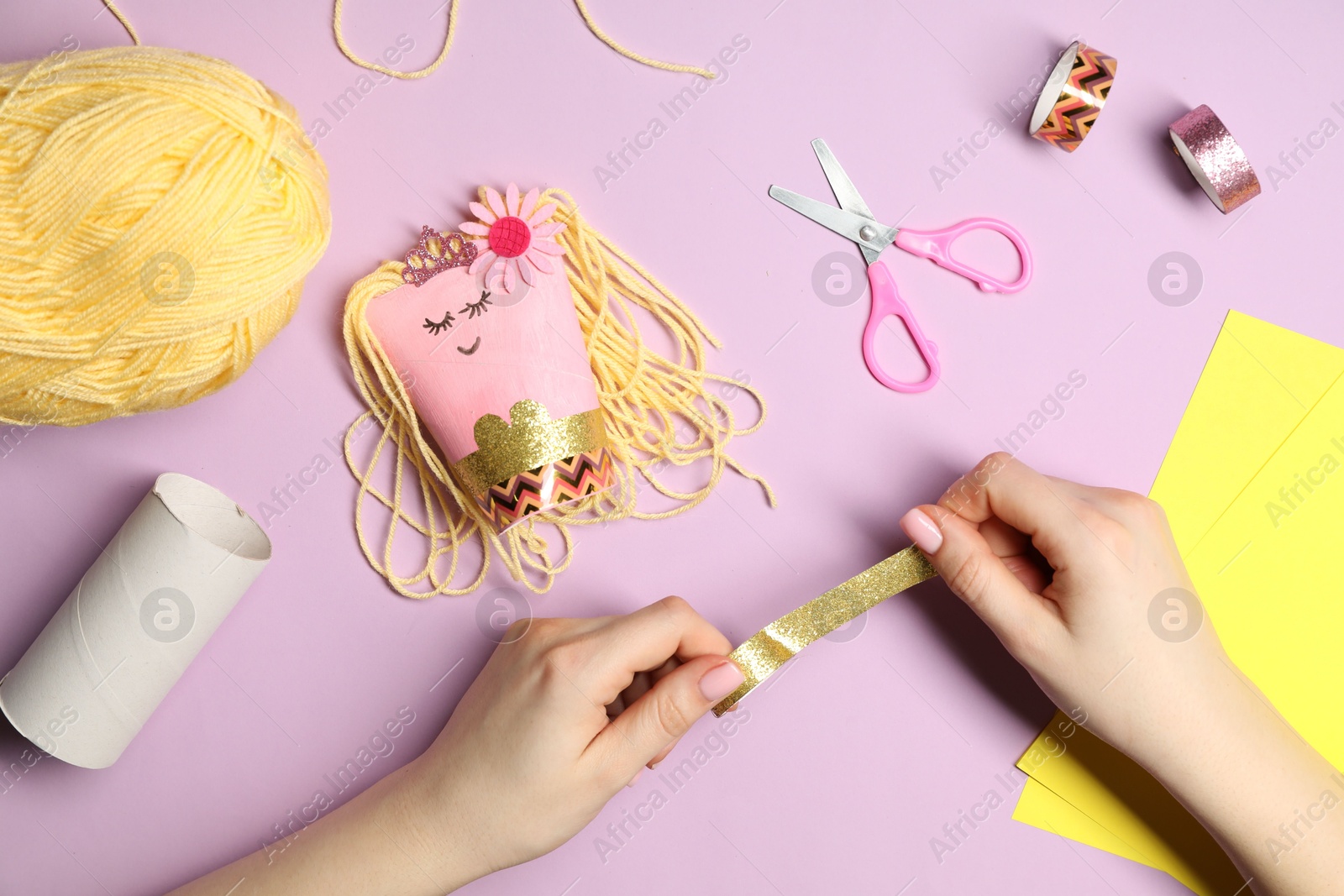 Photo of Woman making craft on violet background, top view