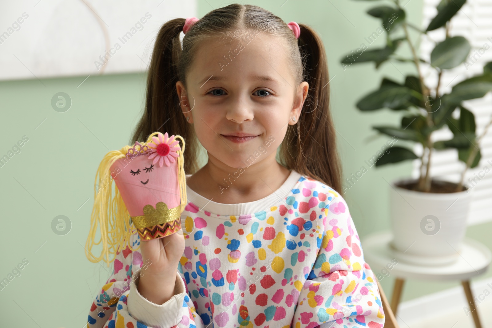 Photo of Little girl with handmade toy at home. Child creativity and craft