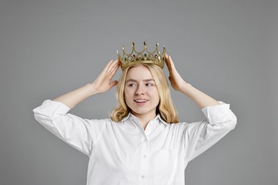 Photo of Happy businesswoman in elegant crown on grey background