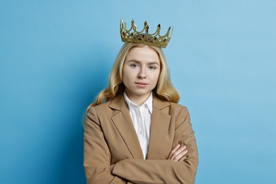 Photo of Businesswoman in elegant crown on light blue background