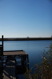 Photo of Beautiful view of river with wooden pier on sunny day