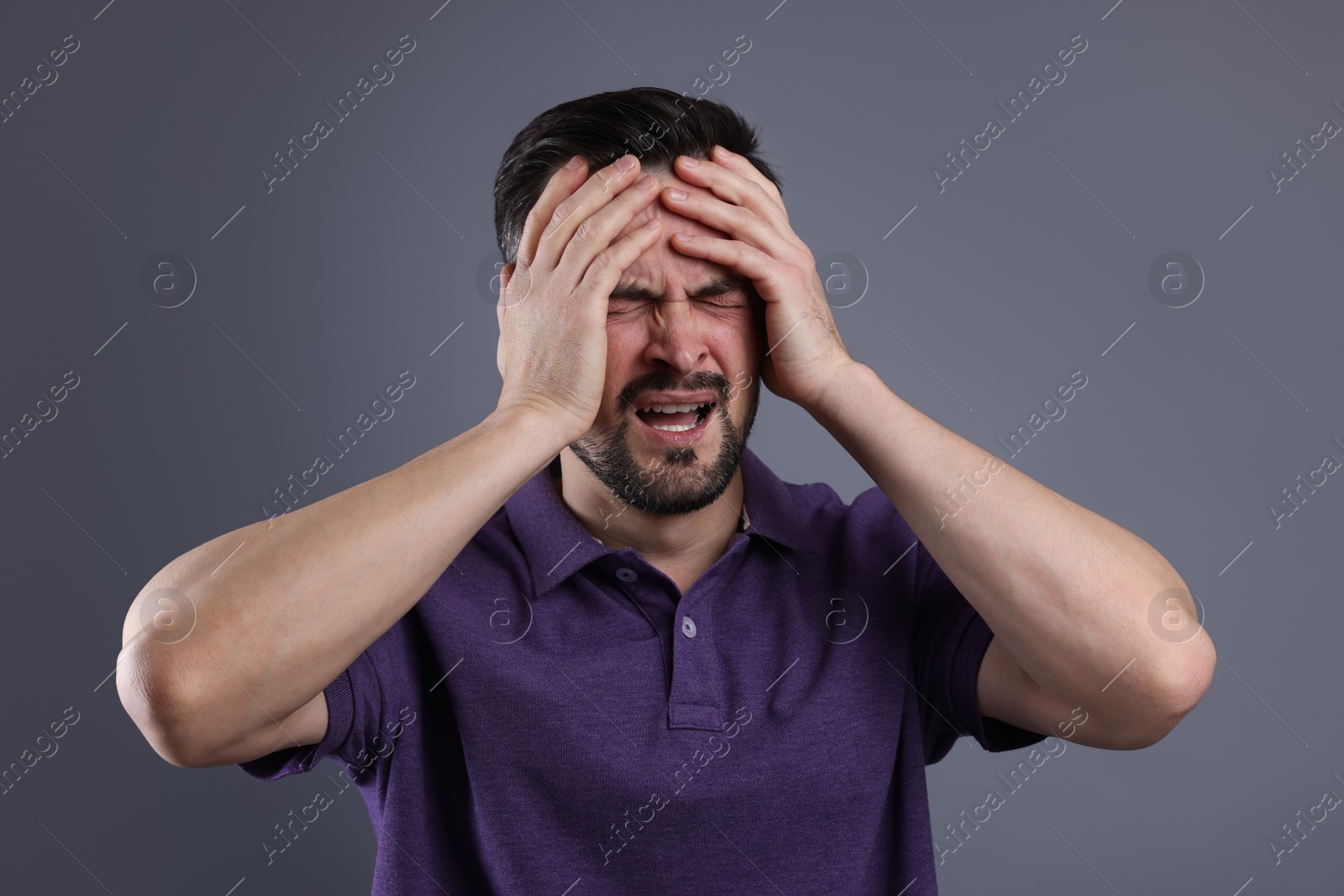 Photo of Portrait of sad man crying on grey background