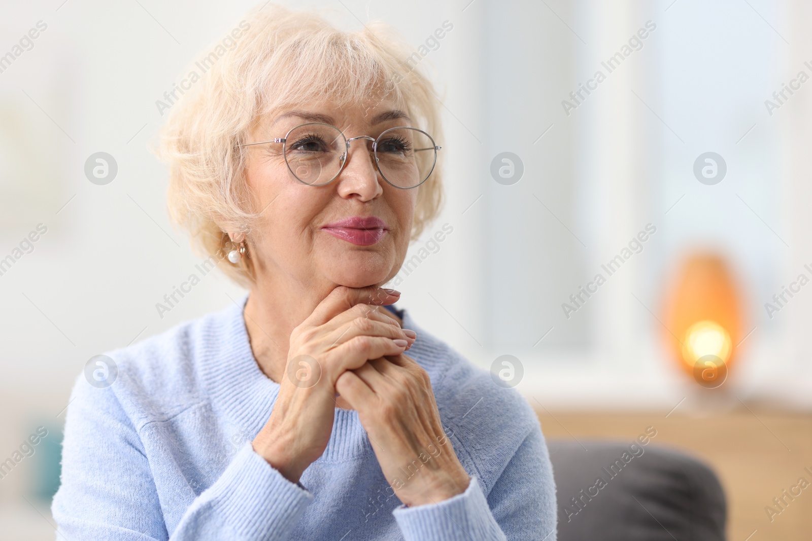 Photo of Portrait of grandmother in glasses at home. Space for text