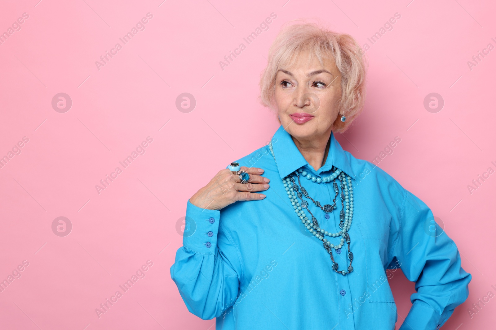 Photo of Portrait of elegant grandmother on pink background. Space for text