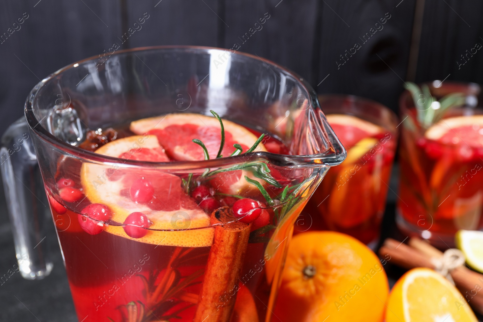 Photo of Delicious punch with rosemary in jug, closeup