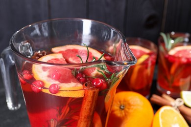 Photo of Delicious punch with rosemary in jug, closeup