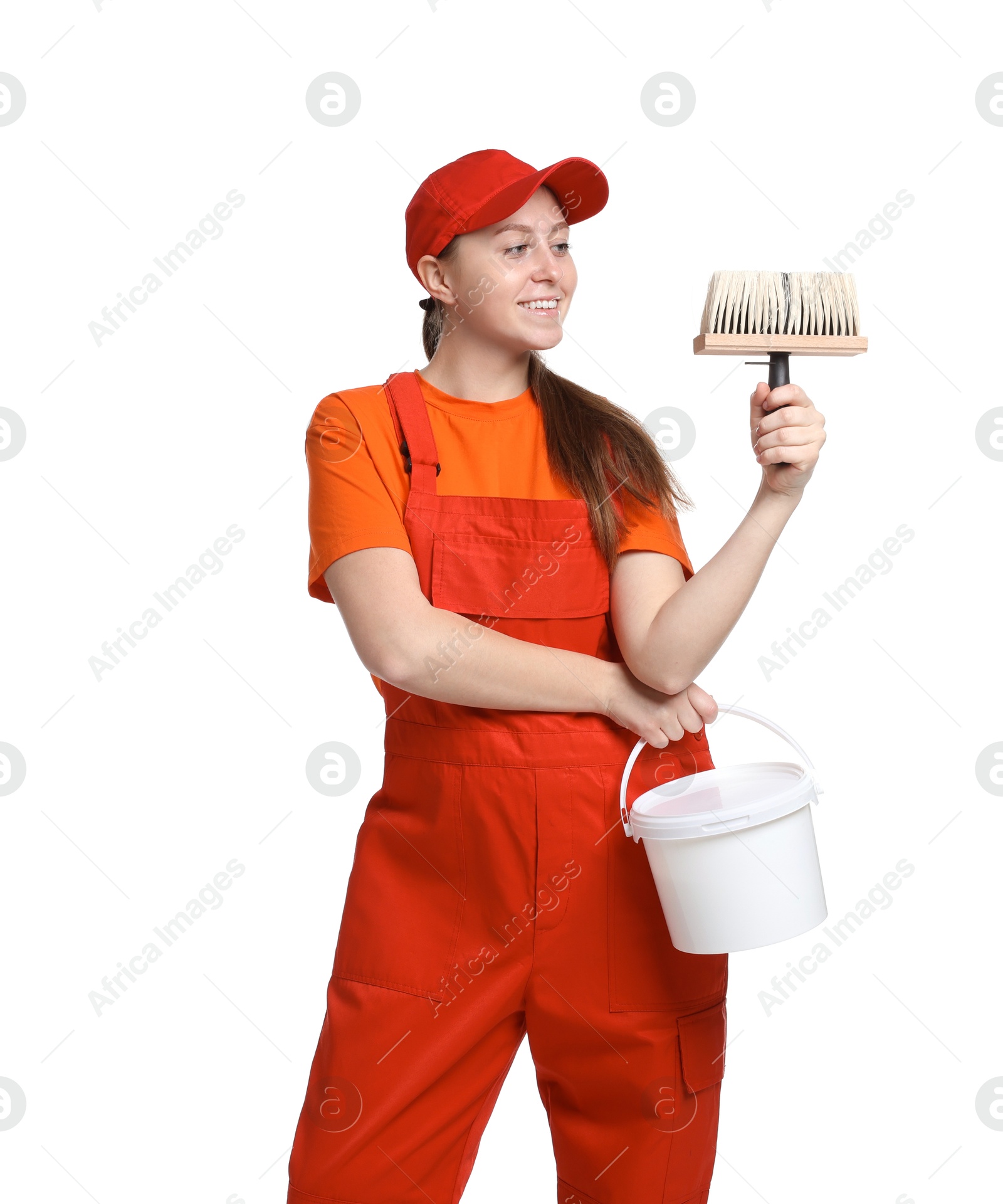 Photo of Professional painter with brush and bucket of paint on white background