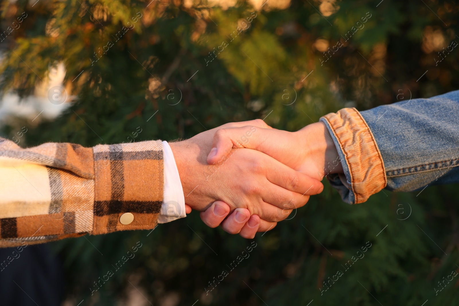 Photo of Help and support. People holding hands outdoors, closeup