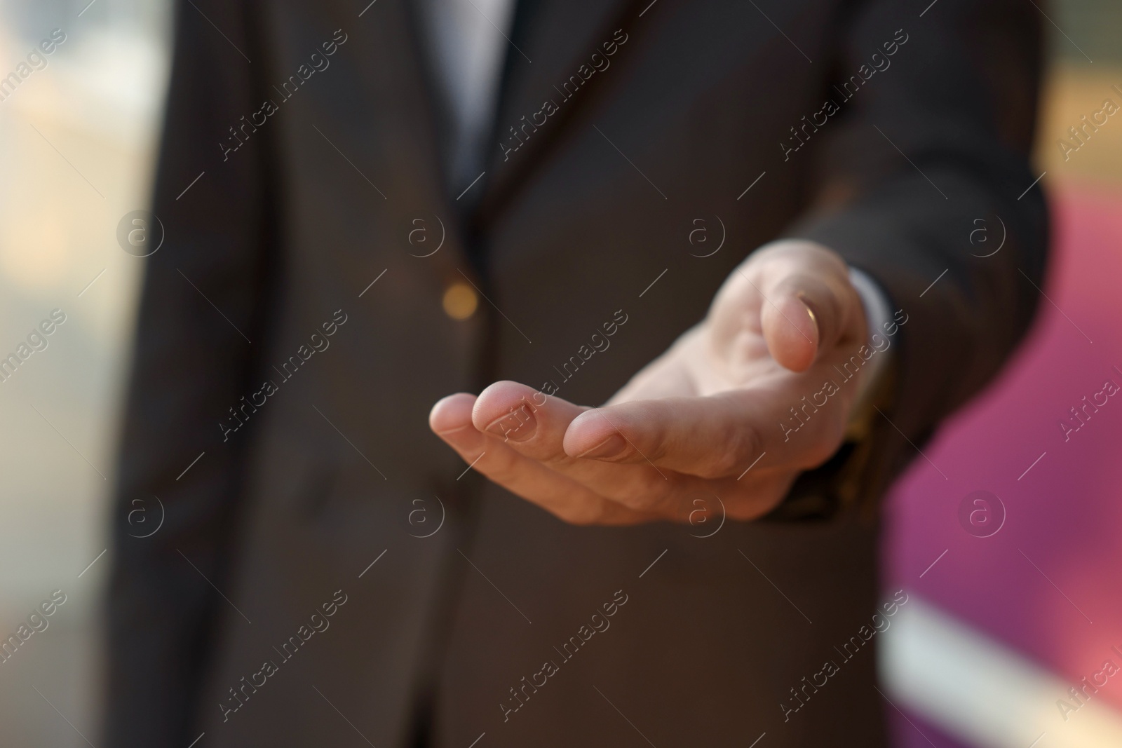 Photo of Man offering helping hand on city street, closeup