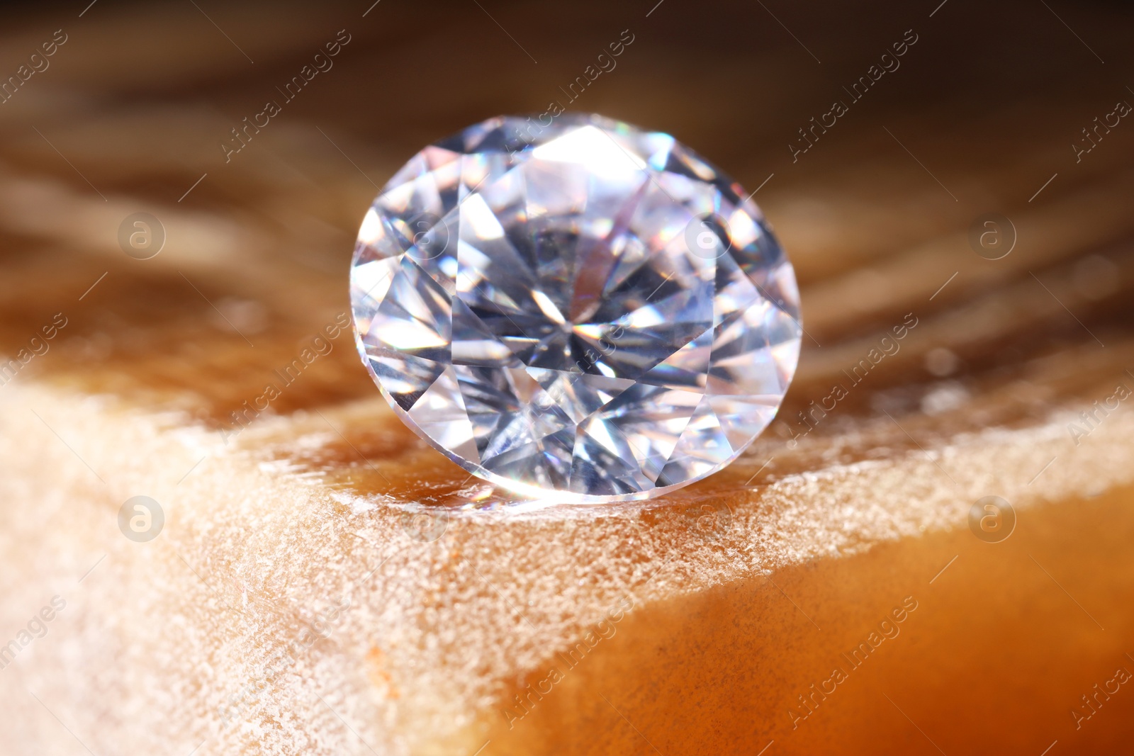 Photo of Beautiful shiny gemstone on stone, closeup view